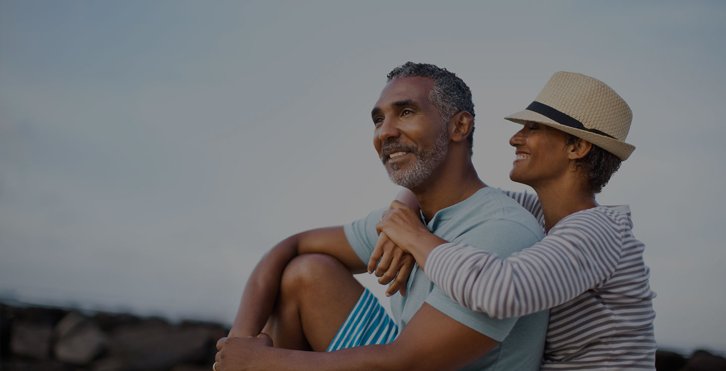 A skin cancer survivor enjoys sitting outside and enjoying a beautiful day with his wife