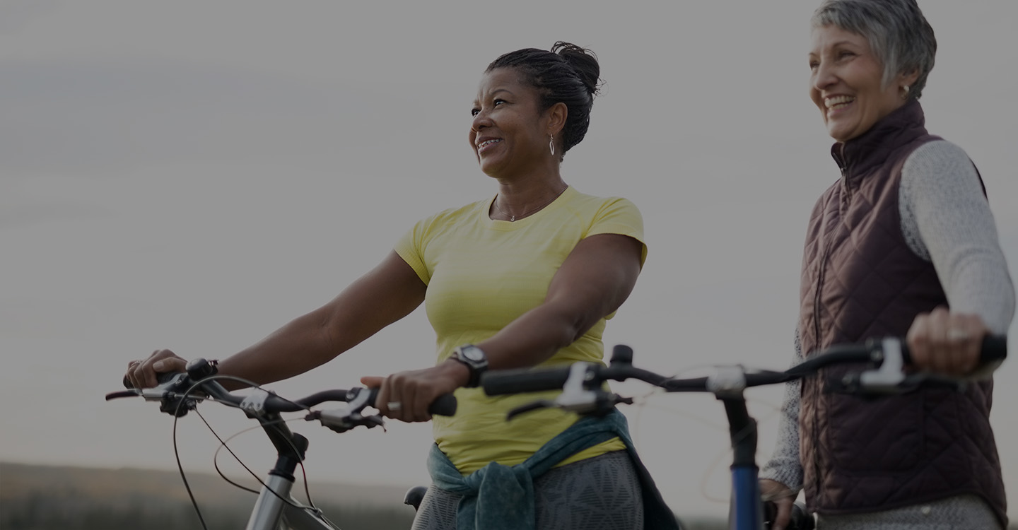 Two women biking to promote lung health