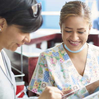 A woman and a Florida Hospital Cancer Institute team member discuss charitable donations and hospital volunteer opportunities