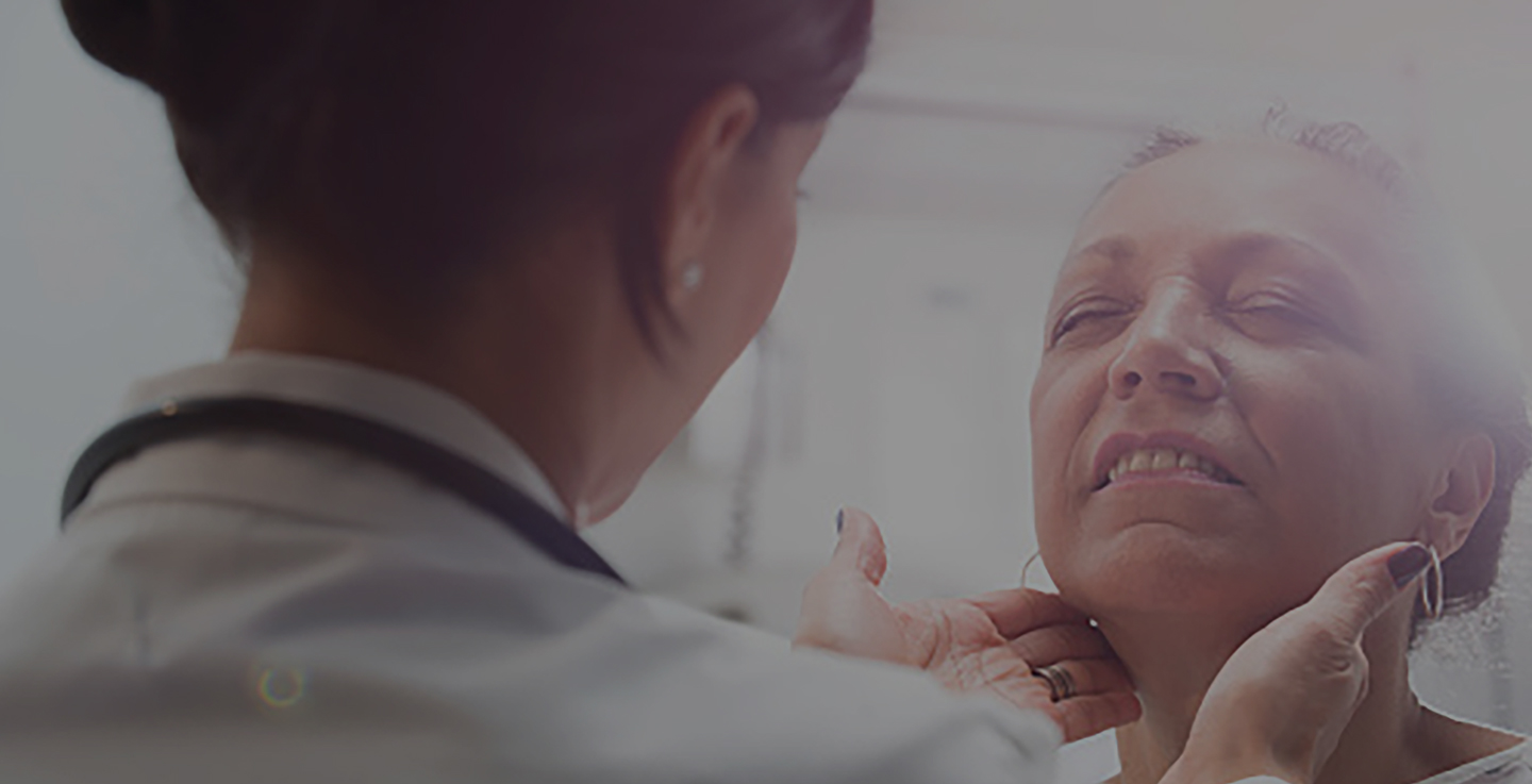 A cancer care specialist screens a patient for cancer symptoms 