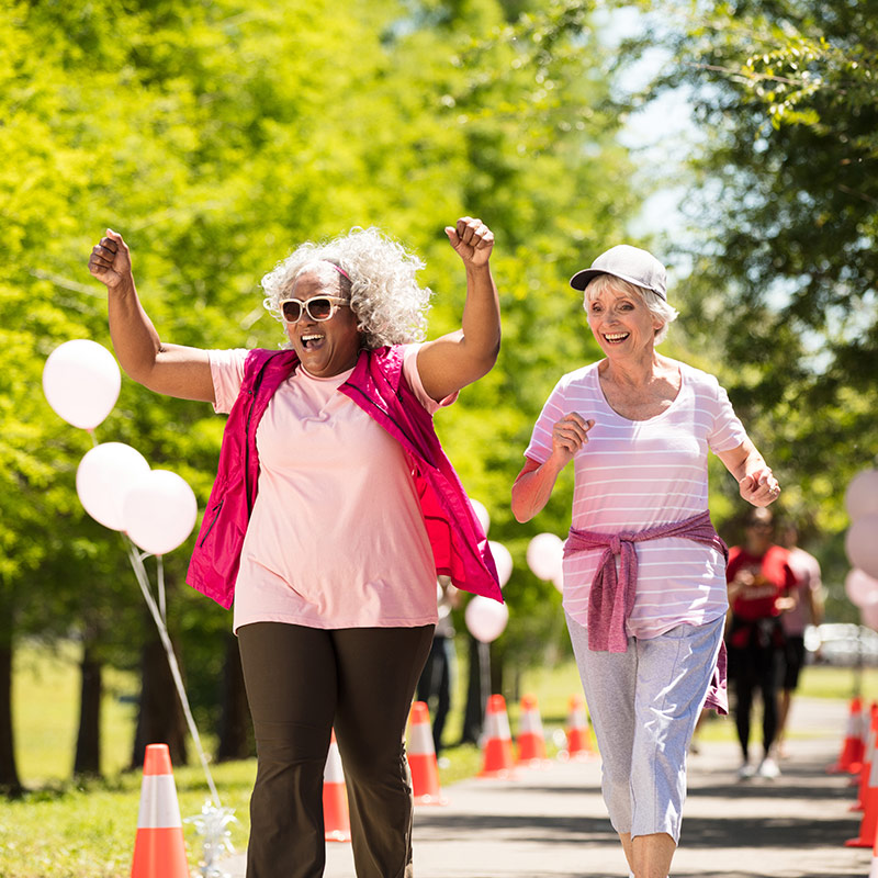 Women running in a race for Breast Cancer Awareness