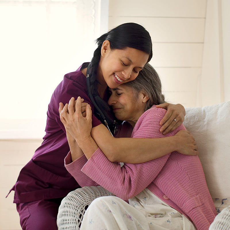 Female patient hugging a nurse