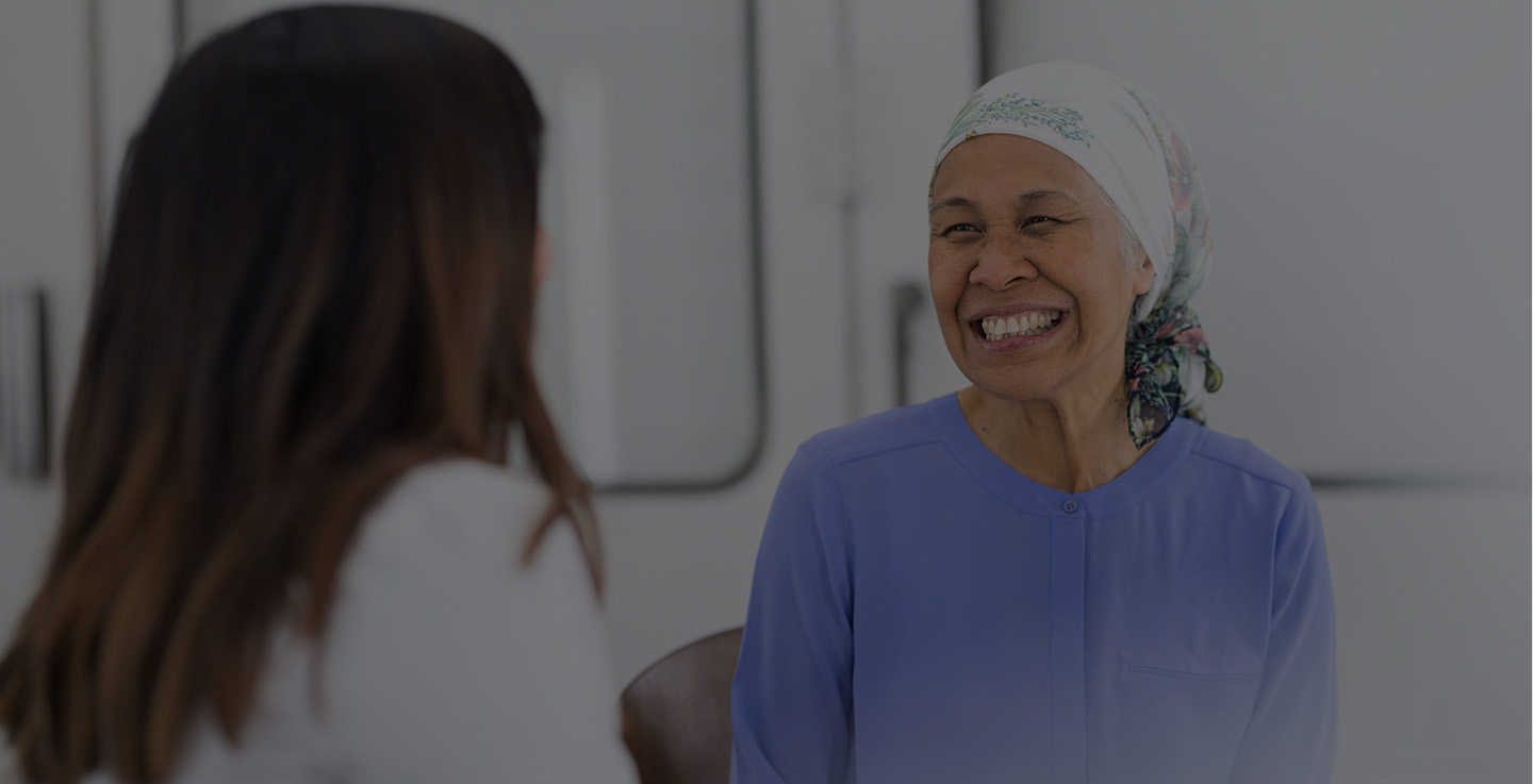 A chemotherapy patient and a cancer treatment specialist smiling