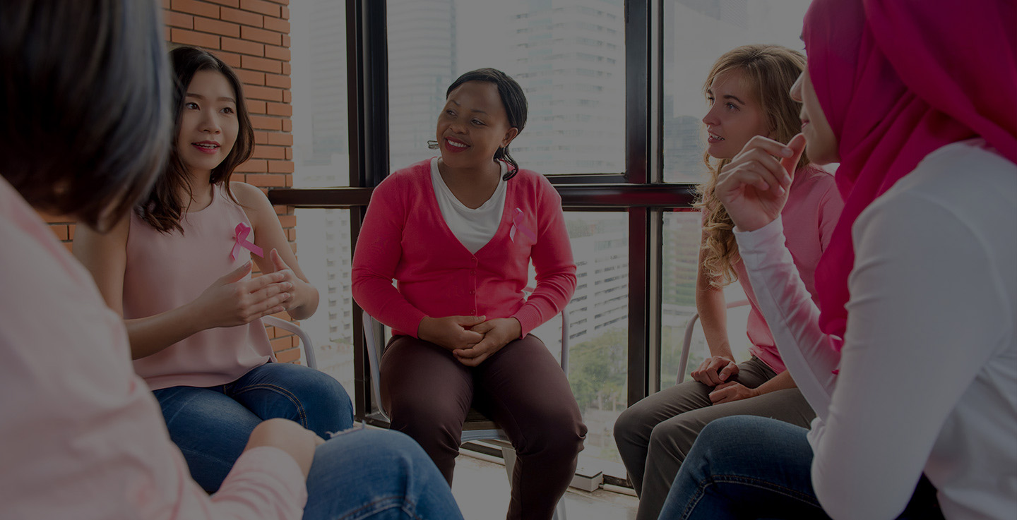 Female patients talking together in a cancer support group