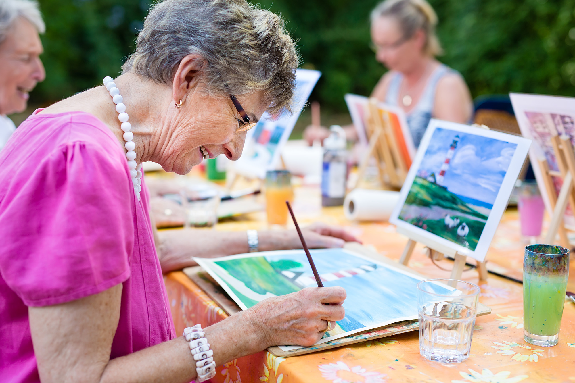 A Senior Lady Painting with a Support Group