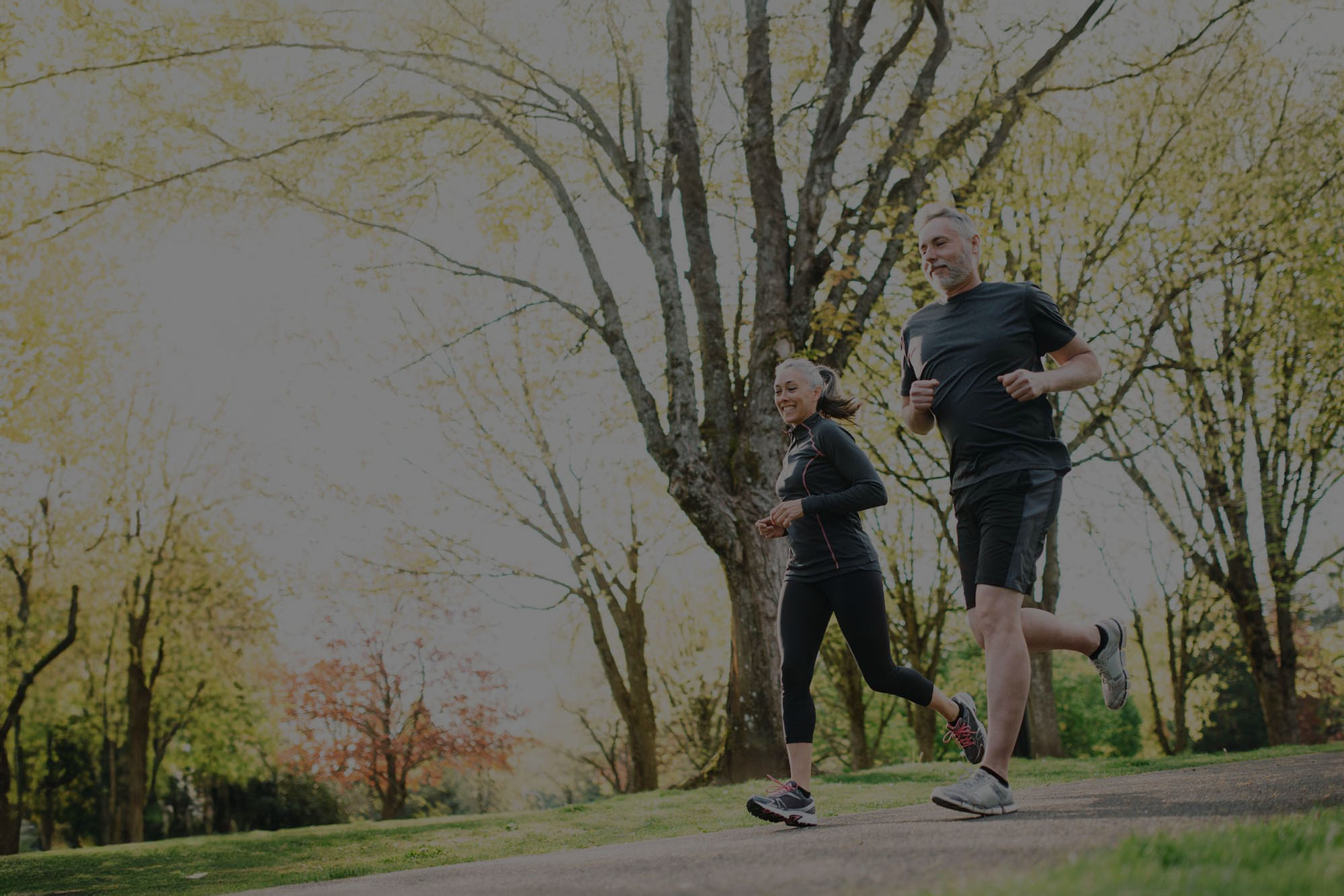 A couple running in the park.