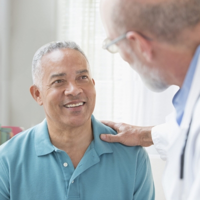 An oncologist and patient discuss cancer prevention, screenings and treatment options