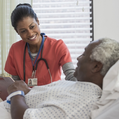 A cancer care specialist discusses clinical trials and cancer treatment options with a cancer center patient 