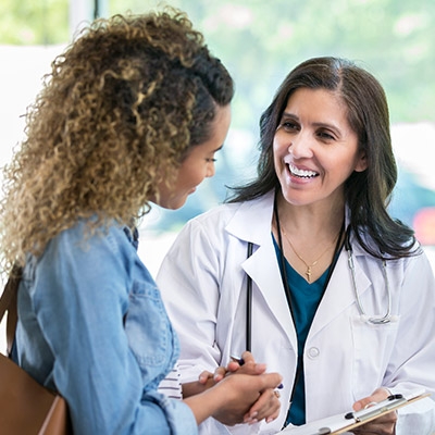 An oncologist and patient discuss cancer diagnosis and treatment options