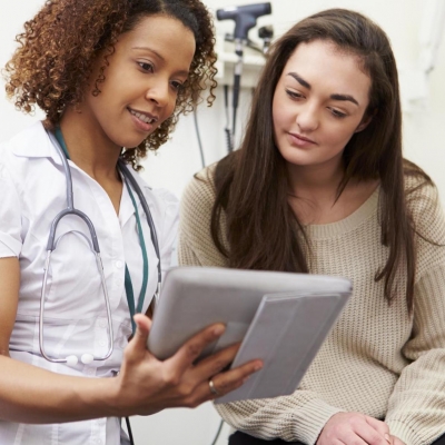Female patient reviewing chart with female nurse