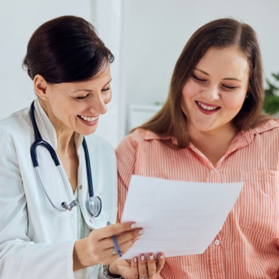 A patient and physician reading a paper with test results.