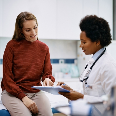 Young woman talking to her doctor